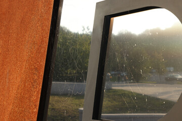 Cobweb on dusty gates outdoors, closeup view