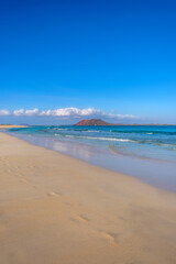 View on Corralejo beach and Lobos island, blue water and golden sand and the Canary Island Fuerteventura, Spain.