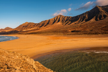 Cofete Beach at sunset on the Canary Island Fuerteventura, view from the little La Islotta.