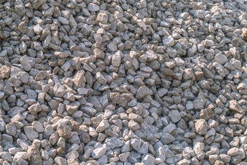 Gravel on the construction site. Construction material for road surface repair. Gravel for the base of the road surface. Gravel background.