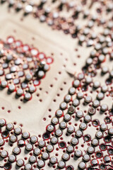 Place where computer chips are soldered onto the motherboard. Recycled motherboard close up.
