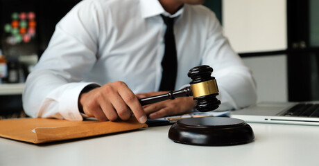 Judge gavel with Justice lawyers having team meeting at law firm in background. Concepts of law.