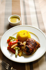 Roasted Chicken With Herb Rice with salad, dip, spoon and fork served on plate isolated on napkin side view of fast food on table