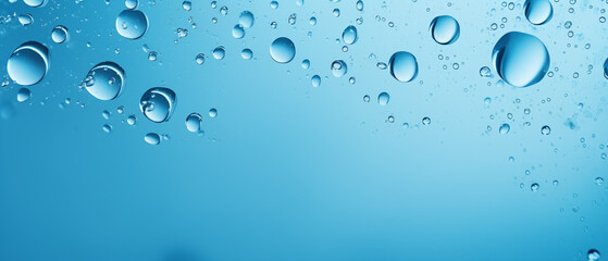 Droplets of water over a clean blue background.