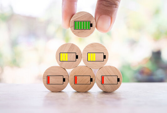 Close up hand arranging green battery full charge. Battery charging icons level, The concept of business, mood, emotion, idea and success.