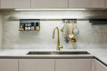 luxury kitchen sink with a gold faucet
