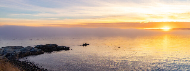 Rocky Shore on the Pacific Ocean Coast. Foggy Sunset. Victoria, Vancouver Island, BC, Canada.