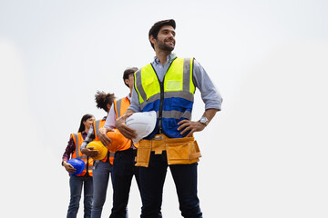 Full length portrait of two men and a woman wearing a reflective safety vests and posing with crossed arms isolated on white background