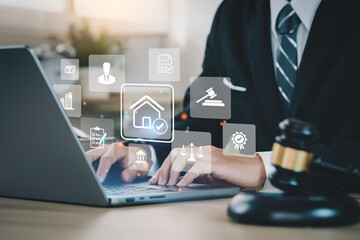 business man uses a computer and house law icons on the dashboard screen to study or search law home, building, or estate and consult a lawyer online tax house