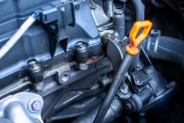 Selective focus to oil leak from engine. Problems with engine lubricant leaking at the cylinder head.