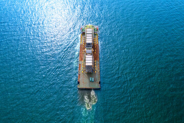Top view Logistics and transportation large cargo ship Transporting loads of oil rig parts