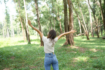 world saving concept Happy female tourist amidst forest