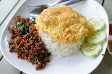 Beef basil, omelet in a plate