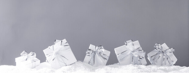 Silver christmas gift boxes in snow