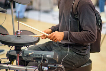 Musician playing drum kit in the concert hall, close-up
