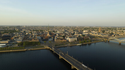Riga, Latvia - AUGUST 20 2023.  an aerial view of a bridge over a river with a city in the background.