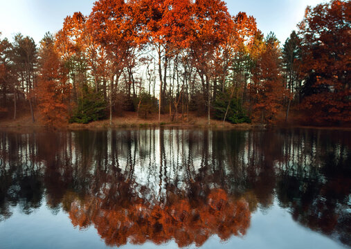 Beautiful colorful autumn trees reflecting on water