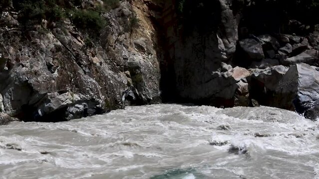 Fresh clear water from flowing along a muddy water in the river