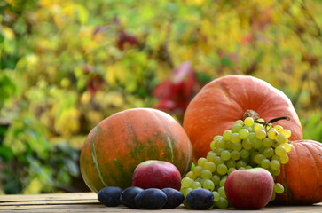 Assortment of fruits, grapes and nuts. Autumn seasonal harvest. pumpkin apples, red, yellow leaves. food still life with season fruits. Thanksgiving day, Halloween decoration fall design