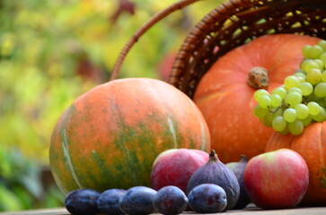 Assortment of fruits, grapes and nuts. Autumn seasonal harvest. pumpkin apples, red, yellow leaves. food still life with season fruits. Thanksgiving day, Halloween decoration fall design
