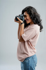 Young woman with professional camera isolated on background