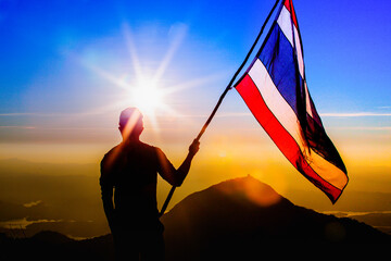 Thailand flag young Asian man on the mountains and nature background Thailand travel, economic concept and democracy.