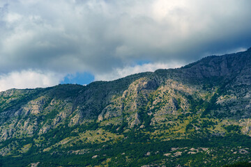 Naklejka premium beautiful mountains and cloudy sky, summer landscape, clouds, forest on the hillsides