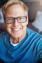 Portrait, mature or happy man in apartment with glasses or freedom on living room sofa to relax. House, face or senior person with smile, peace or wellness in home for a resting break in retirement