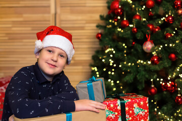 Smiling happy boy with a Christmas present. Christmas. Holidays and events