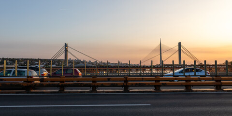 Fototapeta na wymiar Cars and Traffic on Belgrade Bridges of the Sava River, Sunset