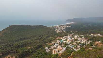 Yarada Beach. The Coast area is surrounded by hills and Bay of Bengal with lush green trees and golden soft sands.