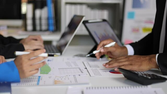 Meeting of business consultants analyzing statistical data, financial graphs and charts.