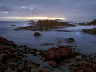 Rocky sea beach at dusk