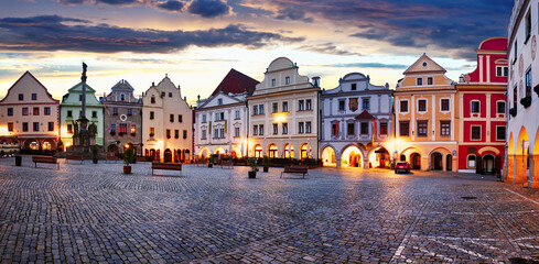 Scenery of the Plaza in Cesky Krumlov, a medieval town in Czech Republic with colorful houses, monument in the square  before sunrise. Czech republic - obrazy, fototapety, plakaty