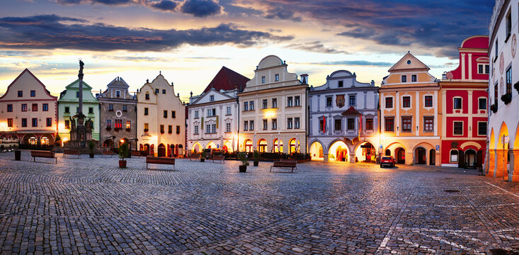 Scenery of the Plaza in Cesky Krumlov, a medieval town in Czech Republic with colorful houses, monument in the square  before sunrise. Czech republic