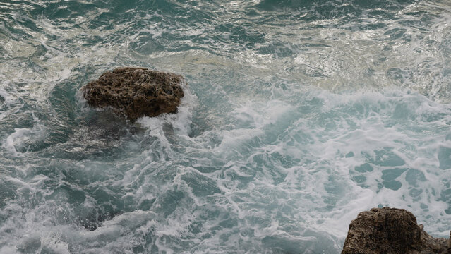 stormy Mediterranean sea waves crushing over rocks
