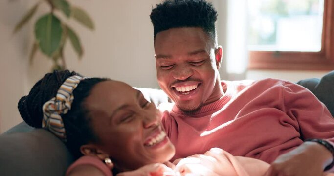 Relax, love and laughing black couple conversation, communication and consulting about marriage, care or trust. Funny joke, home and bonding woman, man or romantic people cozy together on lounge sofa