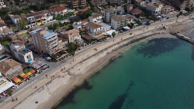 Drone footage over the coastal buildings and Port de Soller Beach in Mallorca, Spain