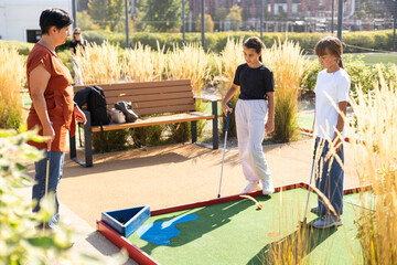 Kids playing golf inside playground artificial grass activity game for children 