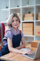 Obraz na płótnie Canvas Portrait Of Asian Female Owner Of Fashion Store Clothing Store successful happy smile at small business, sme or ecommerce concepts