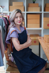 Portrait Of Asian Female Owner Of Fashion Store Clothing Store successful happy smile at small business, sme or ecommerce concepts