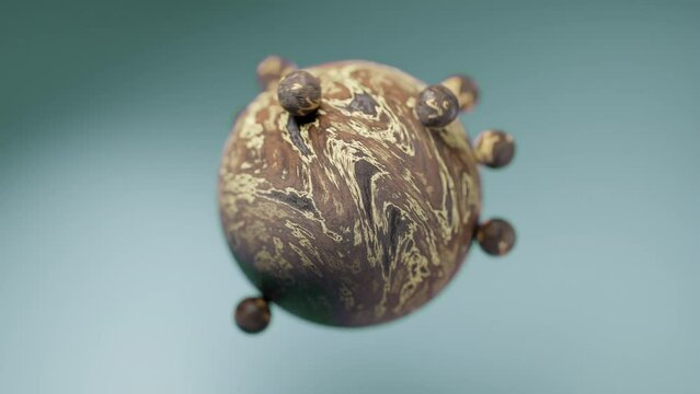 Small brown and creme colored balls orbiting a larger globe against a blue green background
