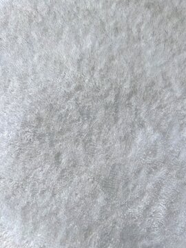 Grey abstract background with fur pile. Fur cloth. Gray fluffy textile surface, fur fabric. Abstract fabric background. Fluffy texture. Grey carpet texture. High quality photos