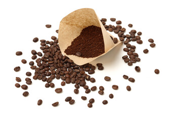 Coffee cone with filter paper full of coffee on white background