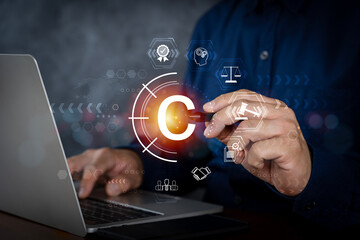 Copyright or patent concept, Person hand using laptop computer on desk with VR screen copyright icon background, Copyleft trademark license.