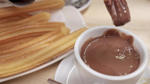 Traditional Spanish Breakfast: Dipping Churros in Hot Chocolate