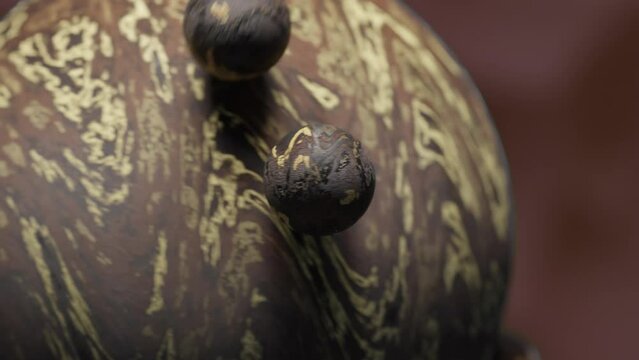 Small brown and creme colored balls orbiting a larger globe
