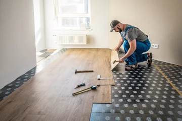 Foto op Canvas Professional worker joining vinyl floor covering at home renovation © Volodymyr Shevchuk