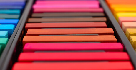 Colored crayons of soft pastels.