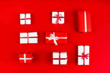 Gift boxes and colorful present for christmas on red background. Top view with copy space.